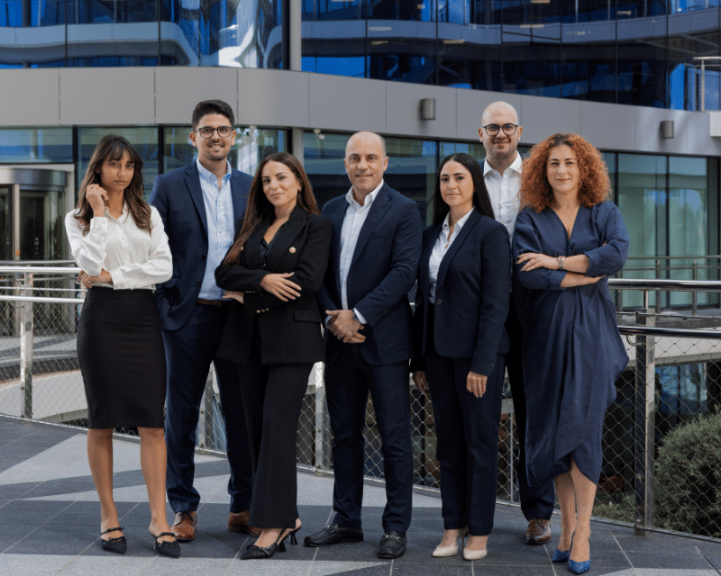 A2CO's Corporate and Legal Department posing at the Qaud Central Malta, in front of A2CO's offices.