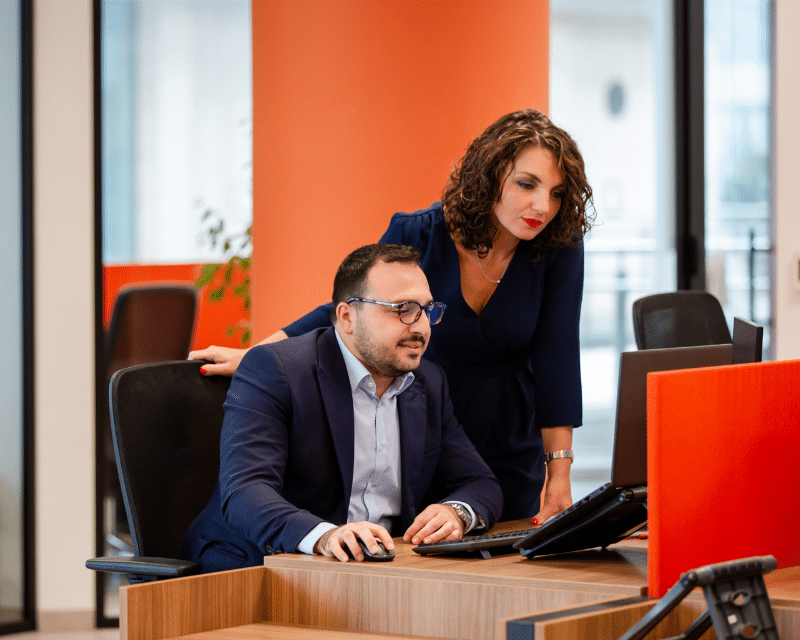 Benjamin Zammit McKeon and Stephanie Bianco, Senior Tax Managers are A2CO looking at a computer screen.