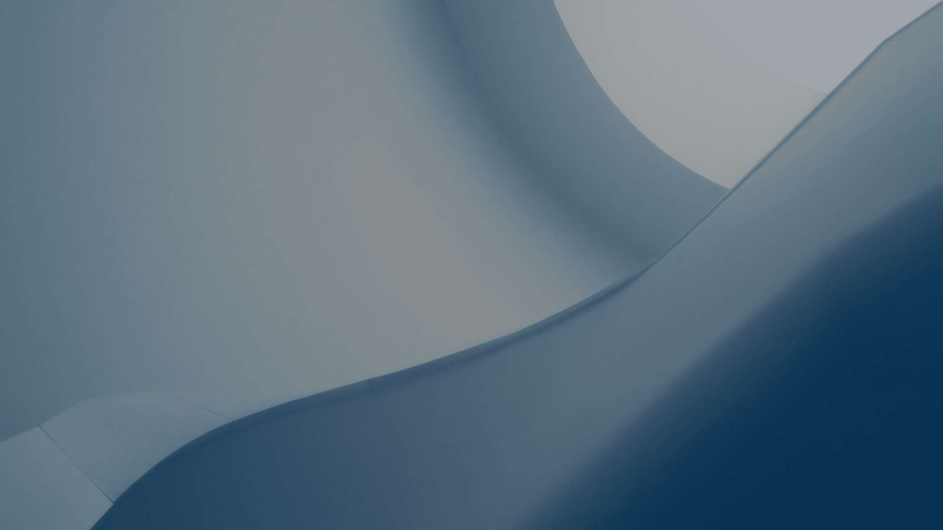 Abstract view of smooth curved architectural surfaces in blue tones.