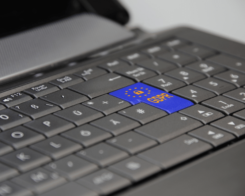 Laptop with GDPR key symbolising A2CO’s privacy and compliance solutions.