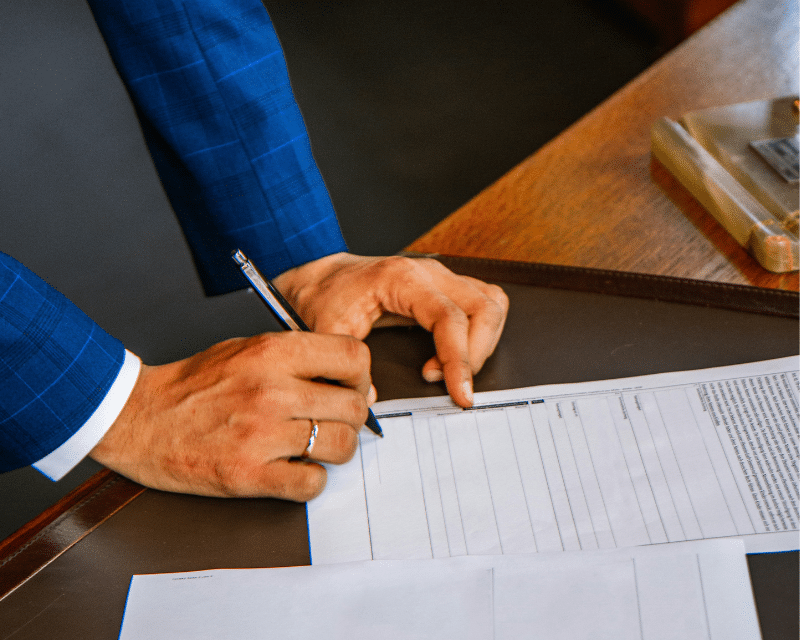 A2CO professional preparing client reports on a laptop in the office.