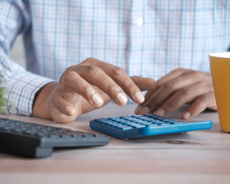 A2CO team member analysing printed business reports during a meeting.