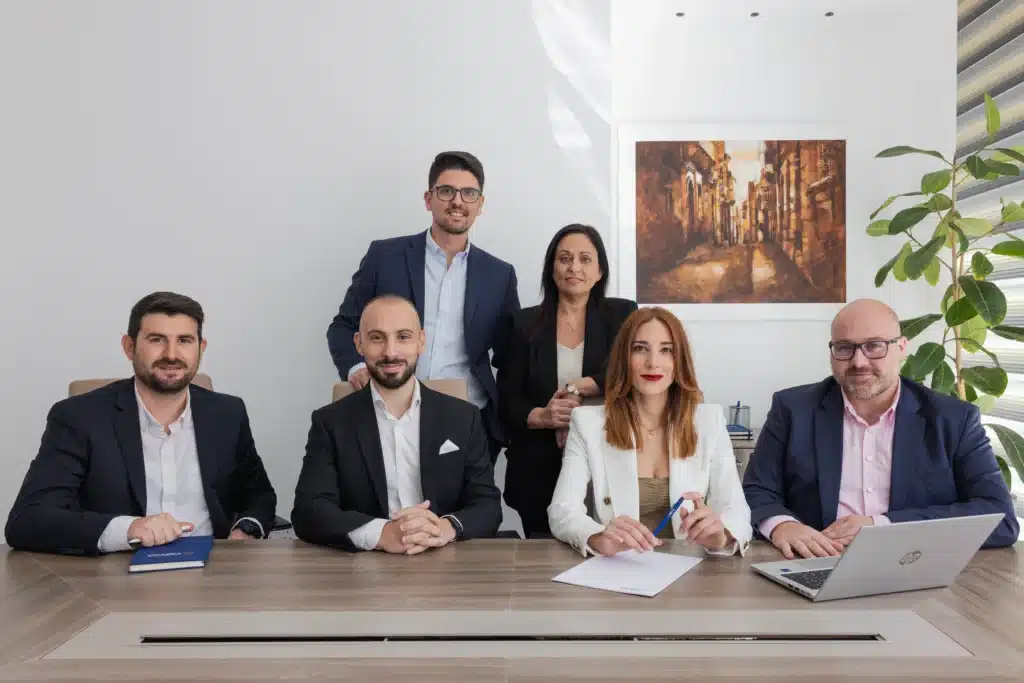 A2CO compliance team including Partner Clinton Cutajar and Compliance Director John Caruana, representing sanctions risk assessment support for iGaming operators in Malta.